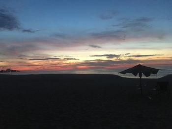 Scenic view of beach against sky during sunset