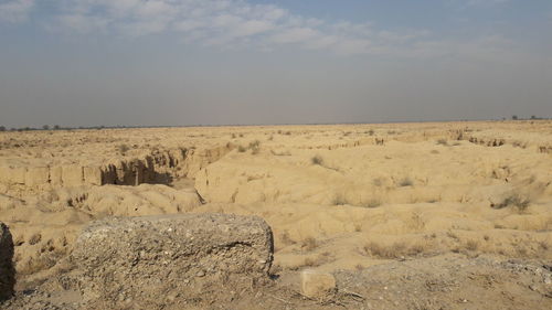 Sand dunes in desert against sky