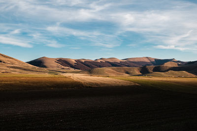 Scenic view of rocky mountains against sky in castelluccio, umbria italy 