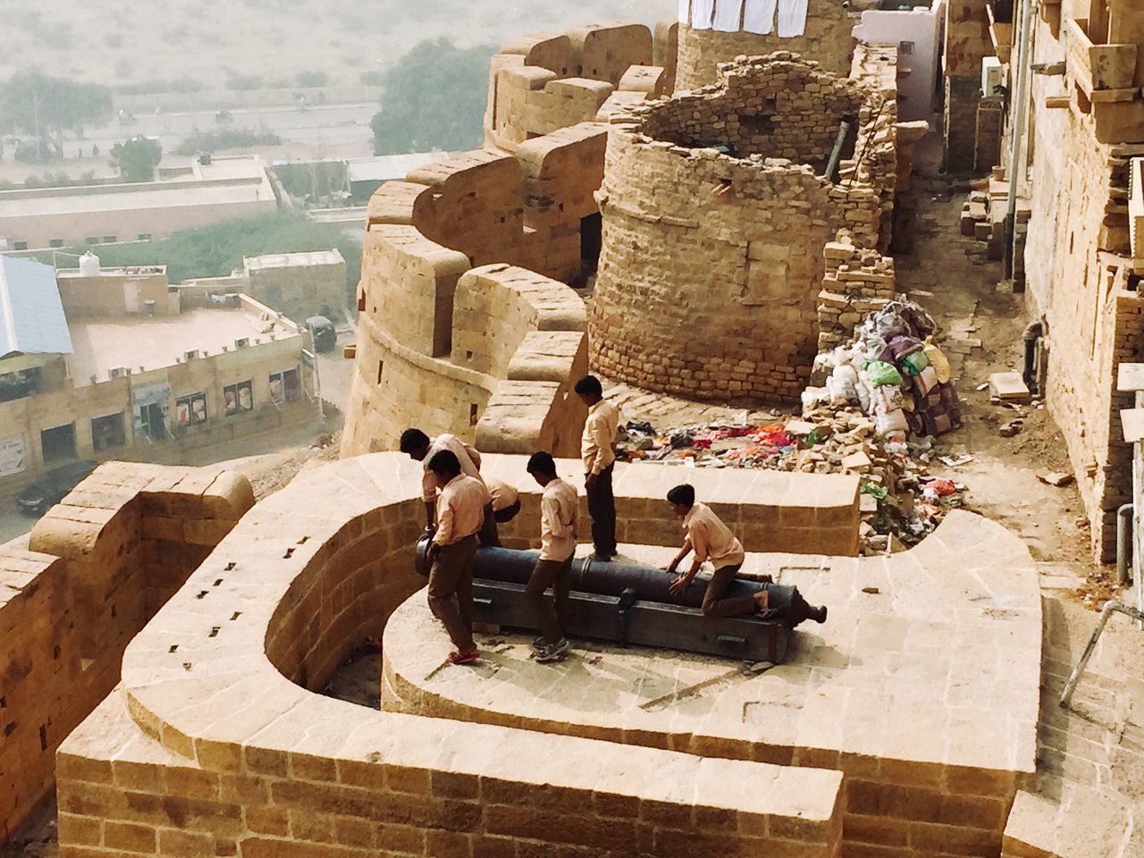 GROUP OF PEOPLE ON THE WALL OF A BUILDING