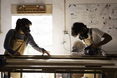 Man and woman standing on table