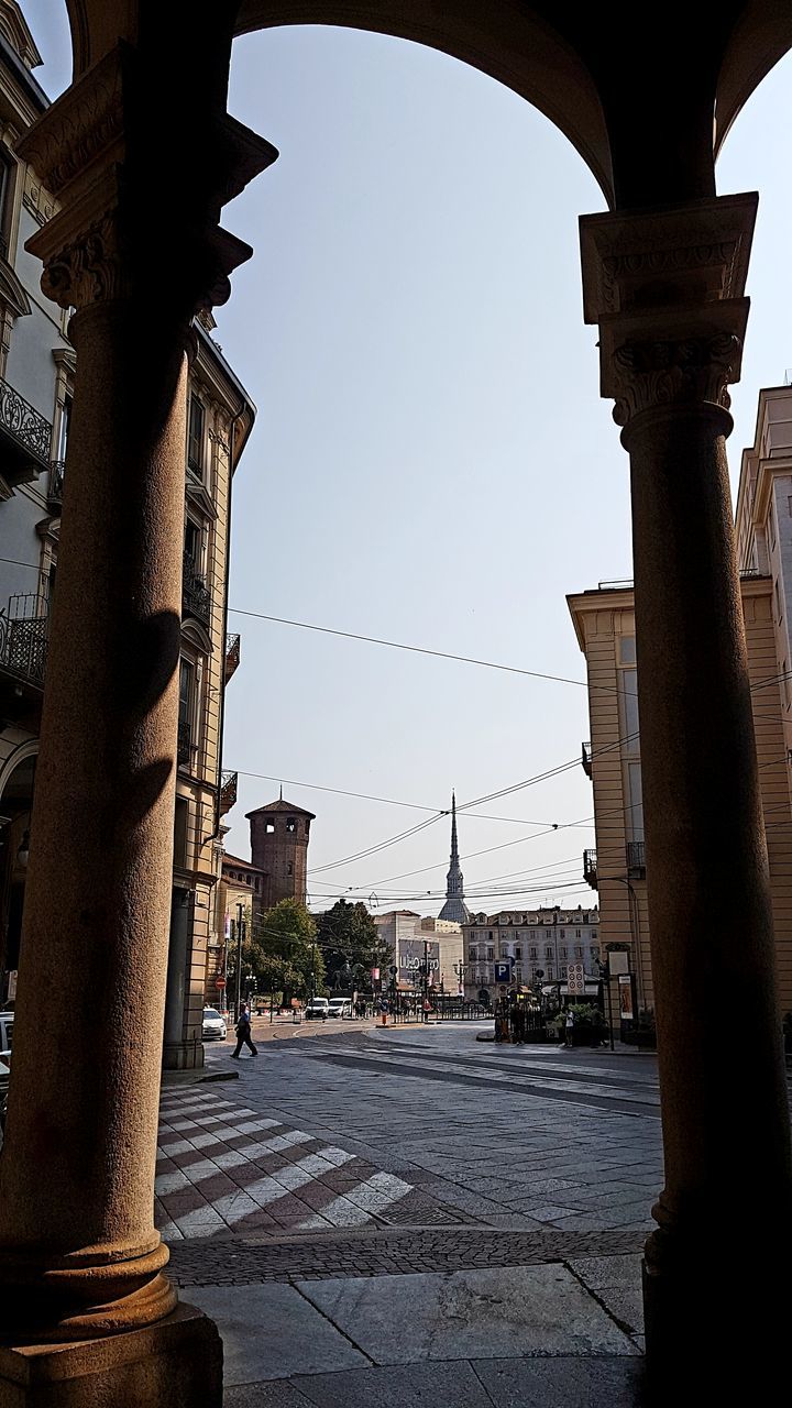 ROAD BY BUILDINGS AGAINST SKY