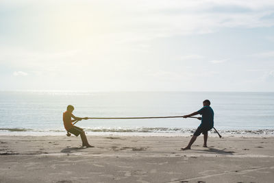 Man standing on beach against sky