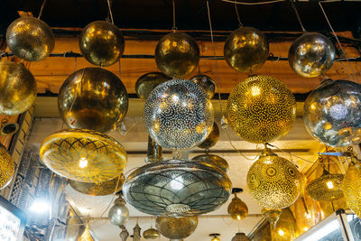 Low angle view of illuminated lanterns hanging on ceiling