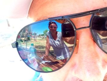 Portrait of man photographing with reflection