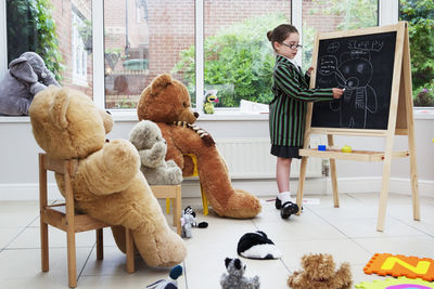 People looking at stuffed toy on table