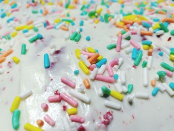 Close-up of multi colored sprinkles on cake