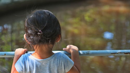 Rear view of woman holding girl