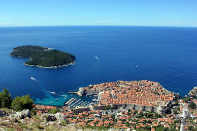 Aerial view of city by sea