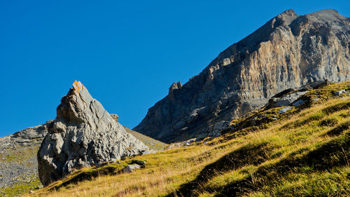 Scenic view of mountains against clear blue sky