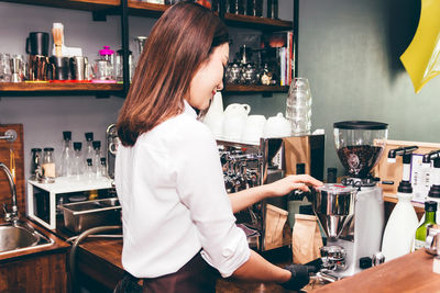 Midsection of woman working at restaurant