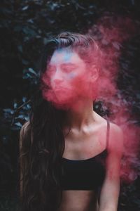 Woman emitting red smoke