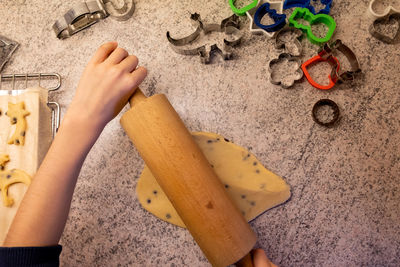 High angle view of hands on cutting board