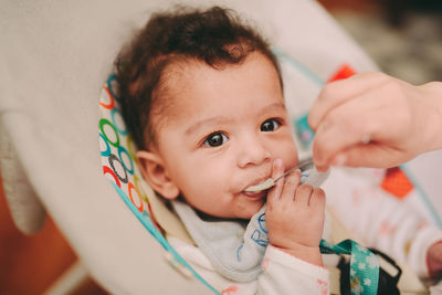 Close-up of cute baby in stroller at home