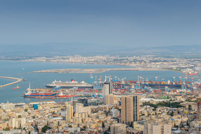 High angle view of buildings by sea against sky