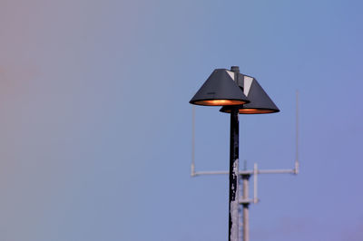 Low angle view of street light against blue sky