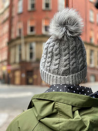 Rear view of woman wearing a knit hat walking in the city