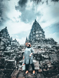 Full length of man standing outside temple against building