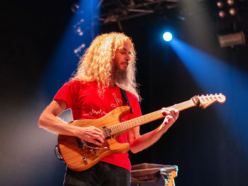 Man playing guitar at night