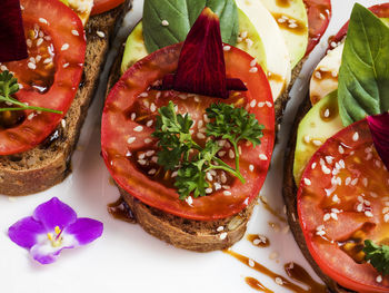 Caviar with grainy cheese and tomatoes on bruschetta