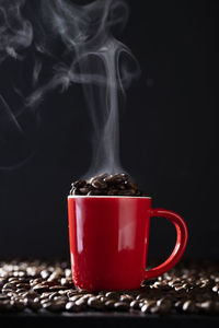 Close-up of coffee cup against black background