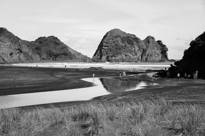 Scenic view of land and mountains against sky