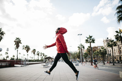 Young man in the city jumping on pavement