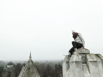Side view of woman standing against clear sky