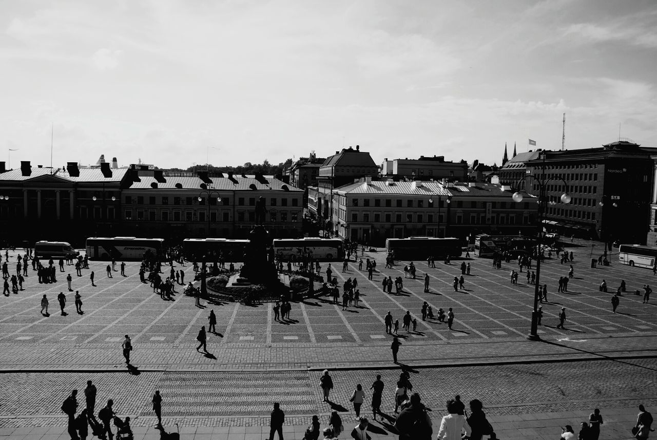 architecture, built structure, building exterior, large group of people, sky, city, travel destinations, person, men, town square, mixed age range, tourism, city life, famous place, crowd, day, travel, outdoors, lifestyles