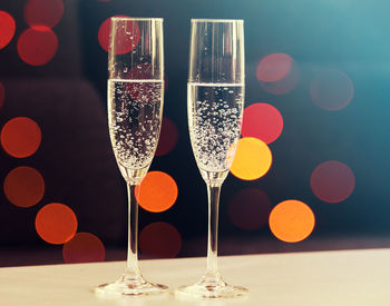 Close-up of wine glasses on table
