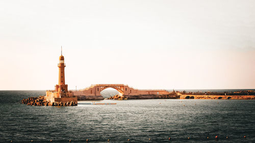 Bridge over sea against clear sky