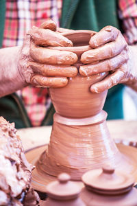 Midsection of man working in mud