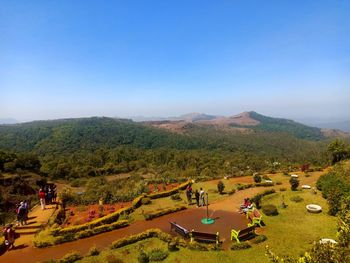 High angle view of people on landscape against clear sky