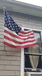 Low angle view of flag against building