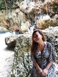 Young woman standing on rock