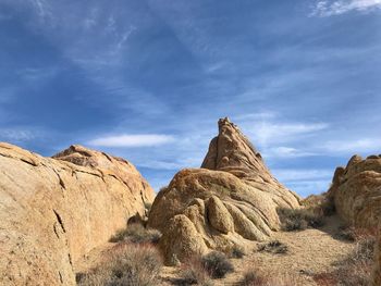 Low angle view of rock formations in desert against sky