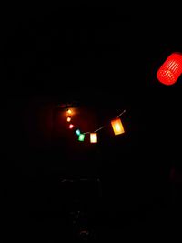 Low angle view of illuminated lantern against clear sky at night