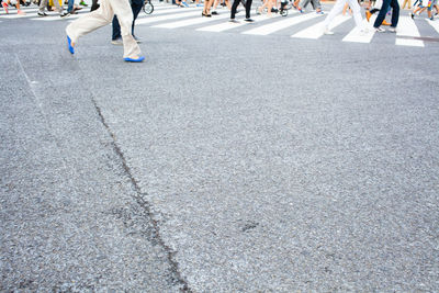 Low section of people walking on road