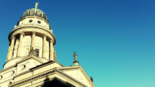 Low angle view of tower against blue sky