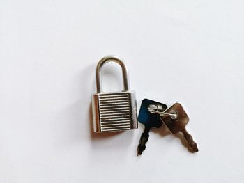 Close-up of padlocks against white background