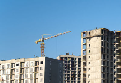 Low angle view of buildings against clear blue sky