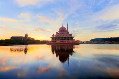 Reflection of buildings in water at sunset