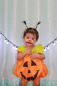 Asian girls make ghosts of red lipstick for halloween