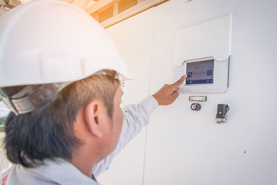 Close-up of engineer operating inverter at solar power station