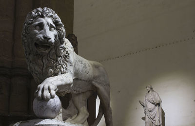 Low angle view of statue against historic building