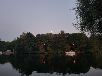 Scenic view of lake against sky at sunset