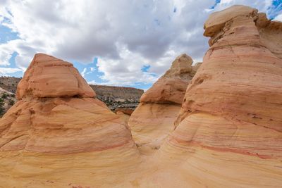 Low angle landscape large yellow striped conical rock formations at ojito wilderness in new mexico