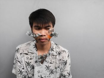 Portrait of teenage boy against wall