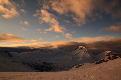 Scenic view of snow mountains against sky during sunset