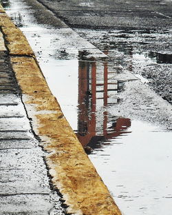 Reflection of building in puddle